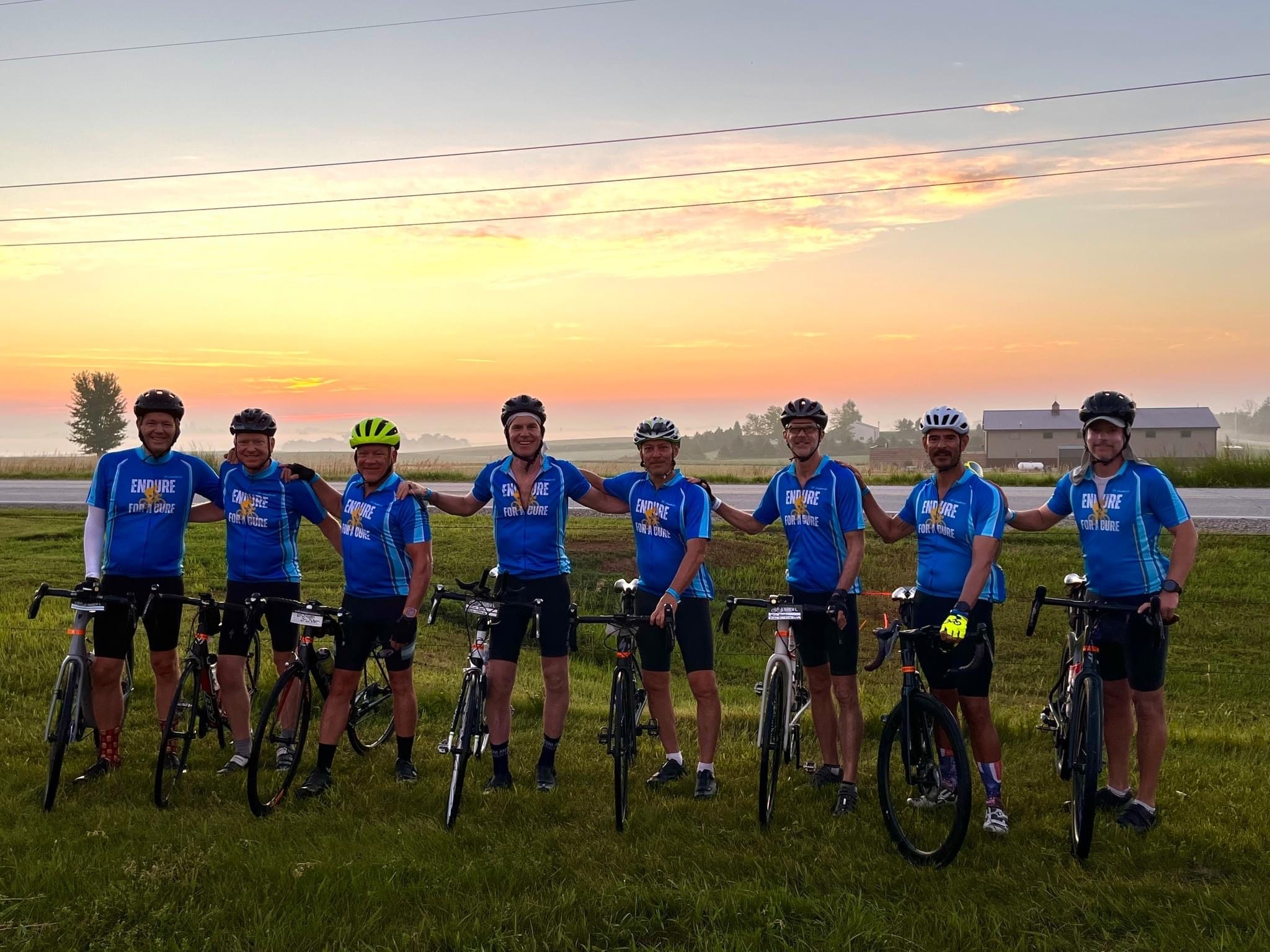 Cyclists posing at sunset