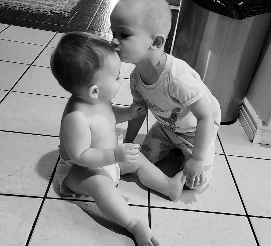Brother kissing little brother